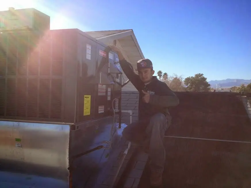 HVAC technician performing AC Tune-Up on a rooftop unit in Hilton Head Island